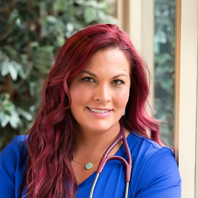 Chiropractor Shannon Hurley In Blue Scrubs With Stethoscope Smiling