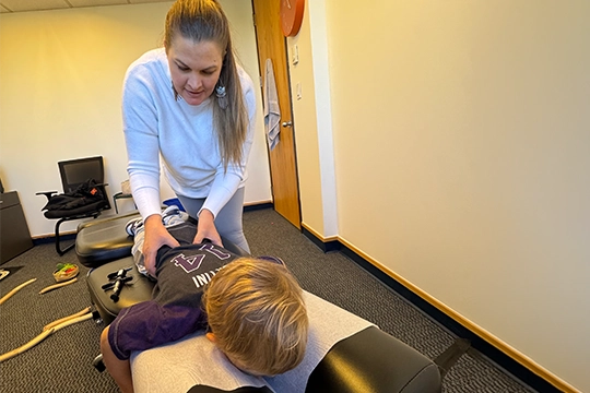 Chiropractor Shannon Hurley Adjusting A Pediatric Patient